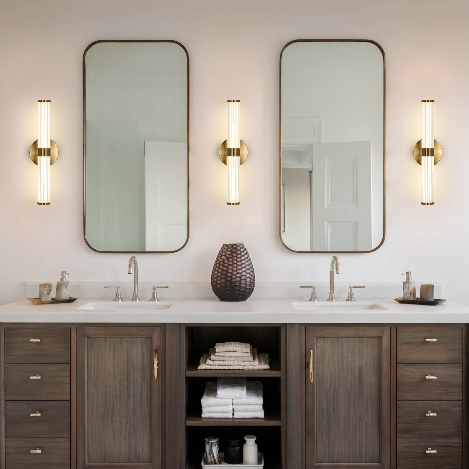 Lighting fixtures layered across a luxury bathroom vanity